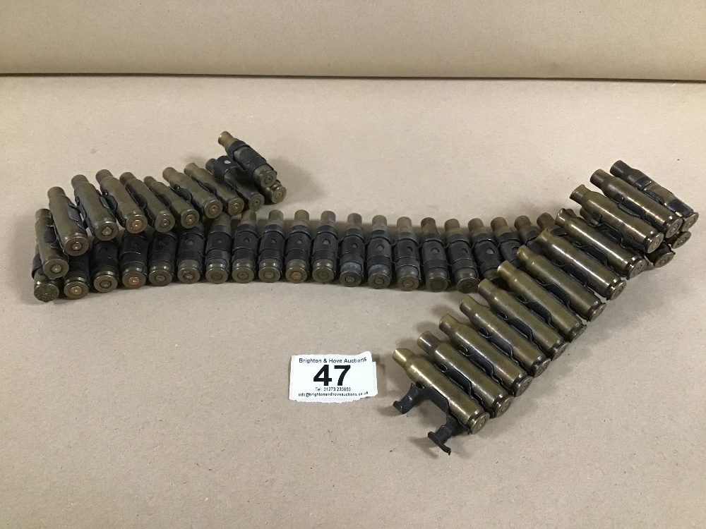 AN INERT AMMUNITION BELT OF 7.62MM BULLETS, 48 IN TOTAL