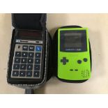 A GREEN GAME BOY COLOR AND A BOWMAR MX70 MEMORY CALCULATOR IN CASE