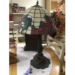 A 20TH CENTURY TIFFANY STYLE TABLE LAMP WITH STAINED GLASS SHADE SHOWING FLORAL MOTIFS, 60CM HIGH