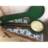 A VINTAGE CASED FIVE STRING BANJO WITH ORNATE INLAY WOOD