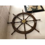 A DECORATIVE WOOD AND BRASS SHIPS WHEEL 12CM DIAMETER