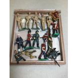 A COLLECTION OF PAINTED LEAD TOY SOLDIERS, INCLUDING THREE HOLDING FLAGS, TWO HOLDING ARTILLERY