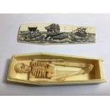 A COPY OF A CARVED BONE SCRIMSHAW COFFIN CASKET WITH WHALING SCENE ADORNING THE LID, OF WHICH