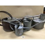 A GROUP OF FOUR GALVANIZED METAL WATERING CANS