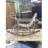 A CHILDS BAMBOO AND WICKER VINTAGE ROCKING CHAIR