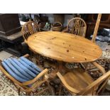 A VINTAGE PINE TABLE WITH FOUR CARVER CHAIRS