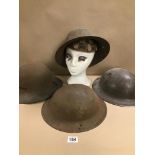 A GROUP OF FOUR WWII METAL MILITARY HELMETS, ONE BY G.C & S LTD SIZE 7 1941