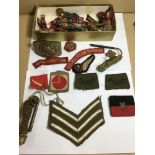 AN ASSORTMENT OF MILITARY BADGE AND PATCHES FROM NUMEROUS DIFFERENT REGIMENTS, INCLUDING ROYAL