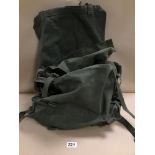 A MILITARY RUCKSACK CONTAINING NUMEROUS SMALL BAGS, SOME DATED 1965 WITH BROAD ARROW MARK