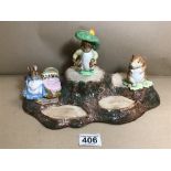 A BESWICK BEATRIX POTTER DISPLAY STAND WITH THREE FIGURES; BENJAMIN BUNNY, HUNCA MUNCA AND TIMMIE