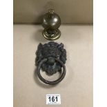 A DECORATIVE BRASS DESK BELL TOGETHER WITH A BRASS DOOR KNOCKER IN THE FORM OF A LION