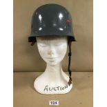 A GREY PAINTED MILITARY HELMET WITH LEATHER LINER