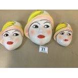 A SET OF THREE GRADUATING CROWN DEVON CERAMIC WALL PLAQUES IN THE FORM OF FEMALE FACES, HAND PAINTED