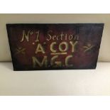 A WWI STYLE MACHINE GUN CORPS SIGN "NO 1 SECTION, 'A' COY, M.G.C" HAND PAINTED ON A WOODEN BOARD,