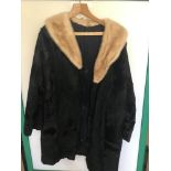 A VINTAGE BLACK AND CREAM FUR COAT SIZE 16-18