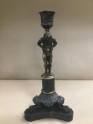 A LATE 19TH/EARLY 20TH CENTURY CONTINENTAL BRONZE FIGURAL CANDLESTICK, RAISED UPON TRIPOD BASE, 28.