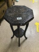 A HEAVY CARVED WOODEN TWO TIER SIDE TABLE