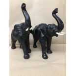 A PAIR OF DARK BROWN LEATHER ELEPHANTS WITH FAUX IVORY TUSKS, 34CM HIGH (AF)