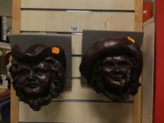 AN UNUSUAL PAIR OF BRONZE EFFECT POTTERY WALL MOUNTING BUSTS