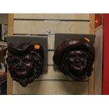 AN UNUSUAL PAIR OF BRONZE EFFECT POTTERY WALL MOUNTING BUSTS