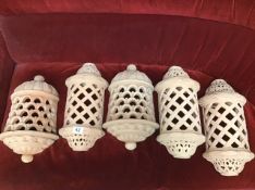 FIVE TERRACOTTA WALL LIGHTS WITH PIERCED DECORATION