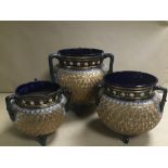 A GRADUATED SET OF THREE ROYAL DOULTON THREE HANDLED GLAZED STONEWARE GLOBULAR VASES/CAULDRONS