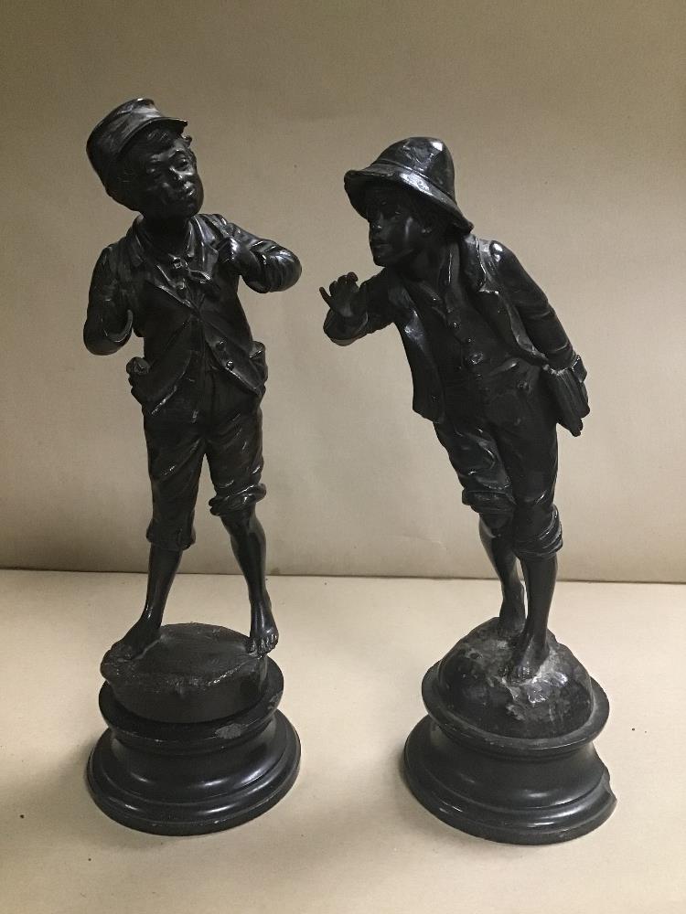 A PAIR OF 19TH CENTURY CONTINENTAL SPELTER FIGURES OF YOUNG MEN, RAISED UPON CIRCULAR PLINTHS (ONE