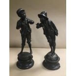 A PAIR OF 19TH CENTURY CONTINENTAL SPELTER FIGURES OF YOUNG MEN, RAISED UPON CIRCULAR PLINTHS (ONE