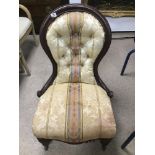 A SPOON BACK NURSING CHAIR ON ORIGINAL CASTORS