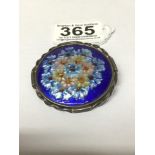 A LIMOGES ENAMEL BROOCH OF CIRCULAR FORM BY JULES SARLANDIE, FLORAL DECORATION ON A BLUE GROUND,