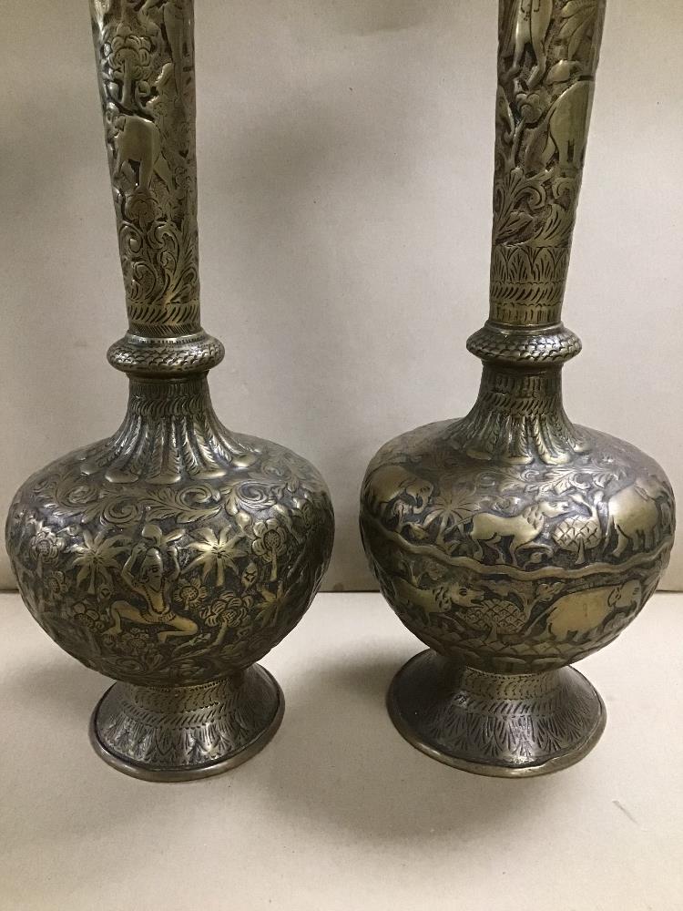 A PAIR OF LARGE INDIAN BRASS VASES WITH HAMMERED DECORATION THROUGHOUT DEPICTING ELEPHANTS AND OTHER - Image 3 of 4