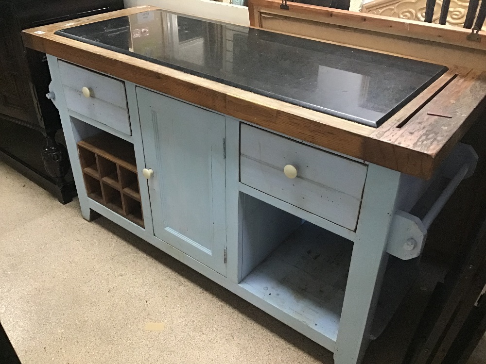 A SOLID WOODEN KITCHEN ISLAND WITH A BLACK MARBLE TOP AND DRAWERS AND A CUPBOARD SPACE IN LIGHT BLUE