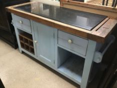 A SOLID WOODEN KITCHEN ISLAND WITH A BLACK MARBLE TOP AND DRAWERS AND A CUPBOARD SPACE IN LIGHT BLUE