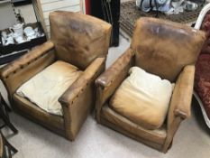 A PAIR OF ART DECO BROWN LEATHER CLUB CHAIRS 1930'S WITH STUDDED ARMS A/F