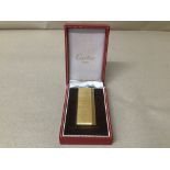 A CARTIER GOLD PLATED ENGINE TURNED POCKET LIGHTER, MARKED TO BASE CARTIER PARIS, 75442H, SWISS