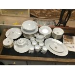 AN EIGHTY PIECE DINNER AND TEA SERVICE HAND DECORATED IN GOLD WITH ORIGINAL PRICE LIST