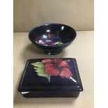 A MOORCROFT DISH AND A SIMILAR LIDDED DISH, BOTH WITH FLOWERS ON A DARK BLUE GROUND, ROYAL