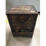 AN EARLY 20TH CENTURY WOODEN TABLETOP STORAGE CABINET, CONTENTS WITHIN BEING A LARGE VARIETY OF