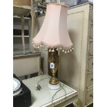 A GILDED TROPHY STYLE LAMP ON MARBLE BASE