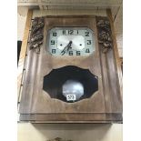 A VINTAGE FRENCH WALL CLOCK WITH PENDULUM