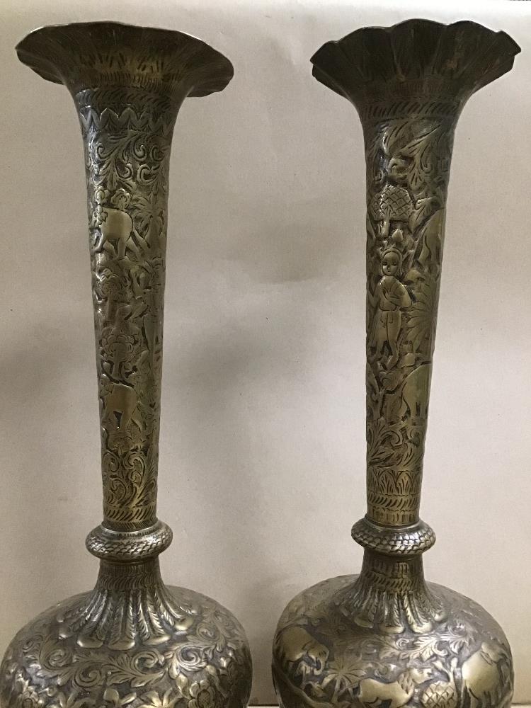 A PAIR OF LARGE INDIAN BRASS VASES WITH HAMMERED DECORATION THROUGHOUT DEPICTING ELEPHANTS AND OTHER - Image 2 of 4