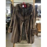 A VINTAGE THREE QUARTER LENGTH MUSQUASH FUR COAT