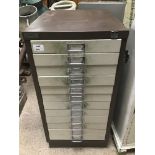 A TWELVE DRAWER FILING CABINET IN METAL WITH CONTENTS FROM A WATCH AND CLOCK REPAIRER