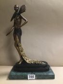 AN ART DECO BRONZE FIGURE OF A SEMI NUDE LADY WEARING A FLOWING FEATHER DRESS, IN THE STYLE OF