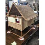 A WICKER AND BAMBOO ORIENTAL STYLE DOLLS HOUSE