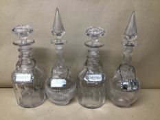 TWO PAIRS OF VICTORIAN CUT GLASS DECANTERS, EACH ADORNED WITH A SPIRIT LABEL, ONE BEING SILVER,