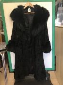 A VINTAGE FULL-LENGTH BLACK ASTRAKHAN COAT WITH FUR TO THE NECKLINE AND SLEEVES, SIZE 12