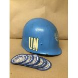 A 1970'S UN TROOPS HELMET, DATED 30TH SEPTEMBER 1971, TOGETHER WITH NUMEROUS UN PATCHES