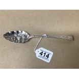 A GEORGE III SILVER BERRY SPOON WITH ORNATELY EMBOSSED BOWL AND ENGRAVED MOTIFS TO THE HANDLE,