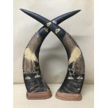 A PAIR OF HIGHLY CARVED ANIMAL HORNS RAISED UPON WOODEN BASES, 42CM HIGH